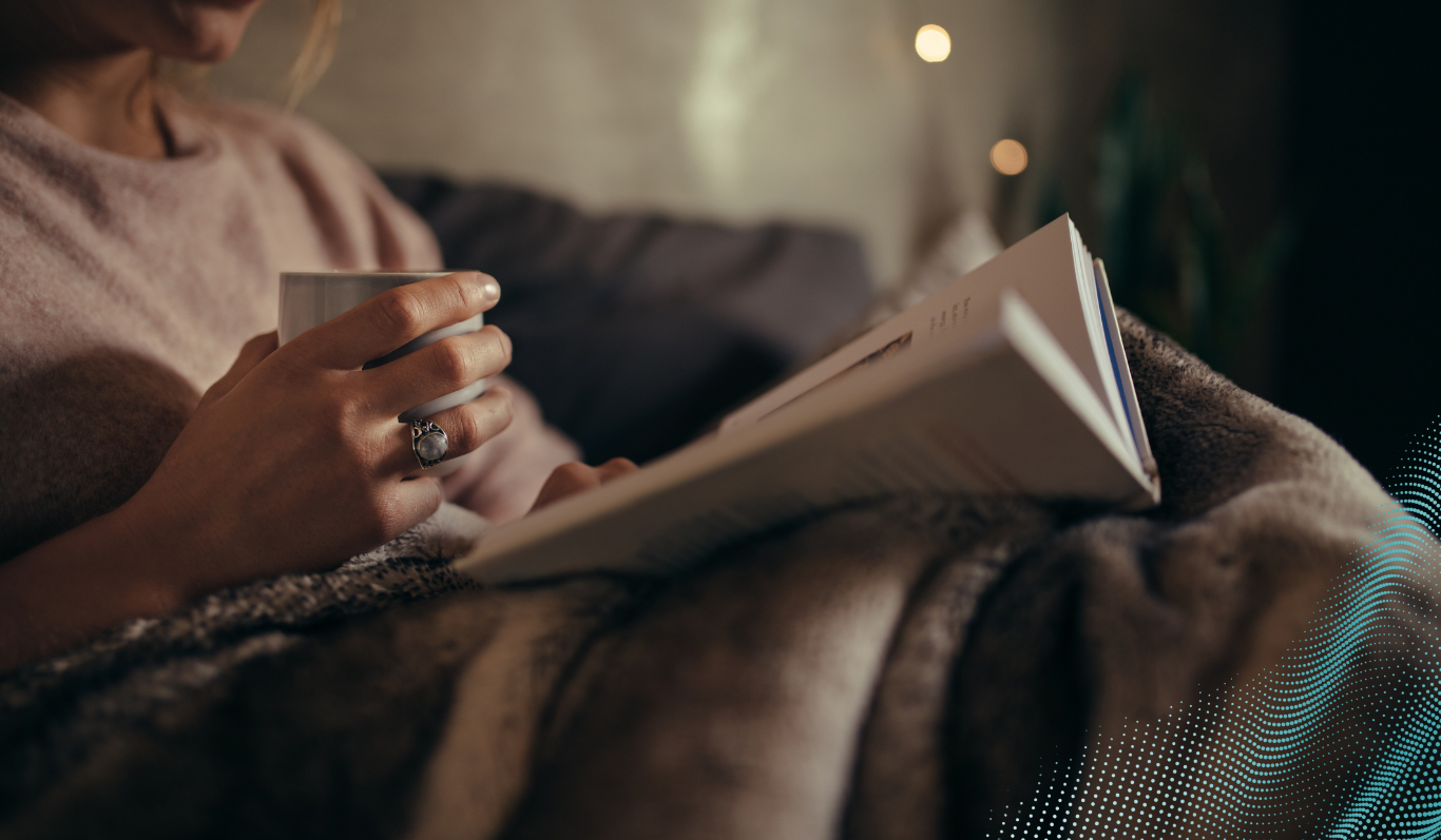 A person reading a book in a dimly lit room 