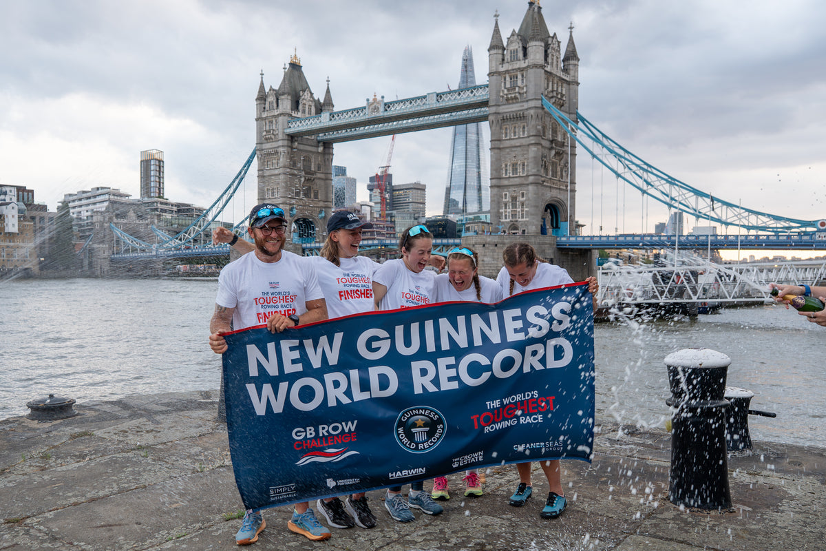 Team Nautilus holding a Guinness World Record banner at Tower Bridge after completing the GB Row Challenge 2026